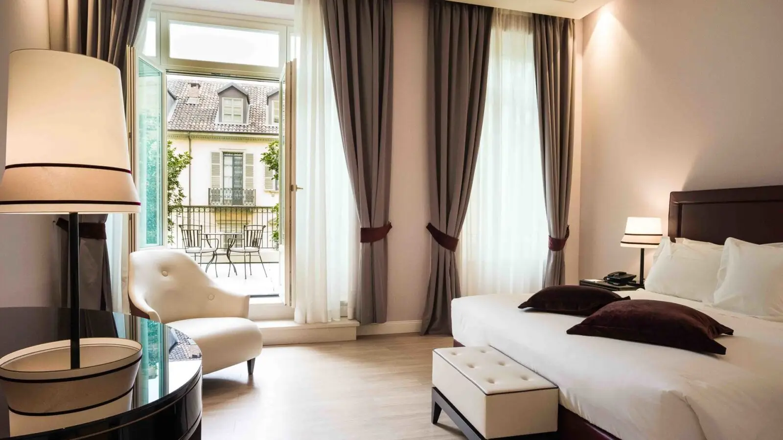 Turin Palace Hotel guest room with tall windows