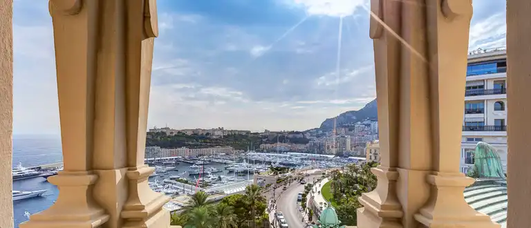 Monaco harbour viewed between terrace columns