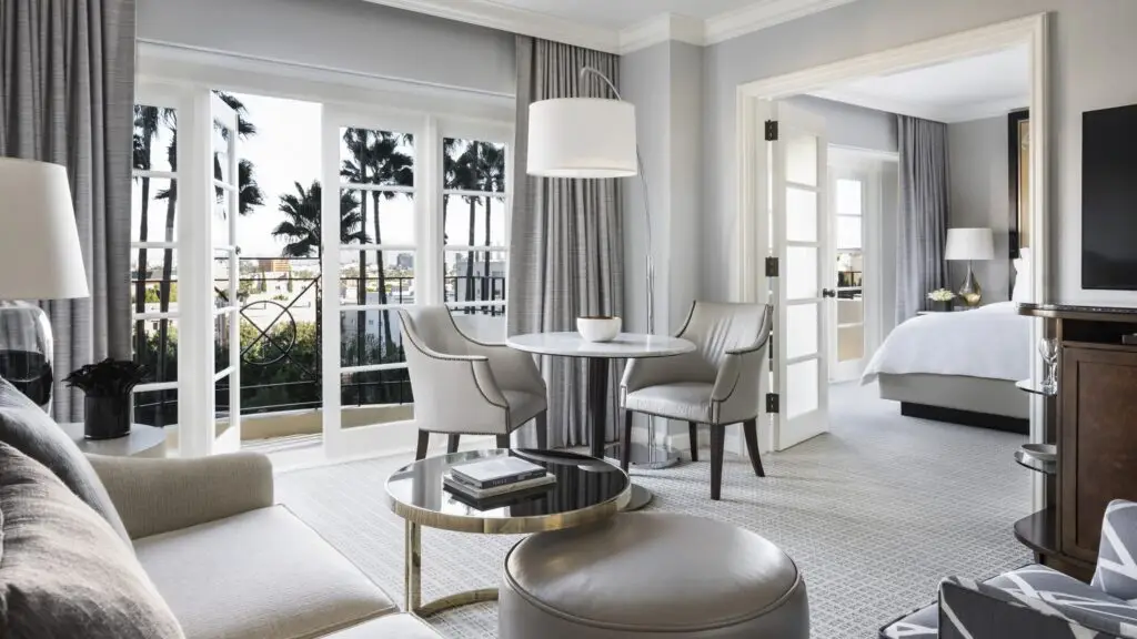 Hotel suite with a dining area, bedroom and garden views