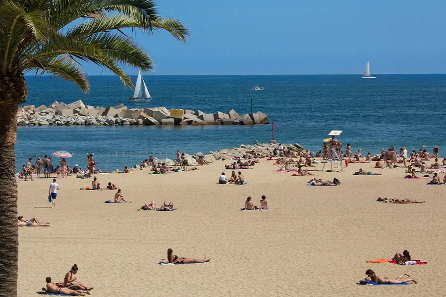 Sunbathers and boats at a Barcelona beach