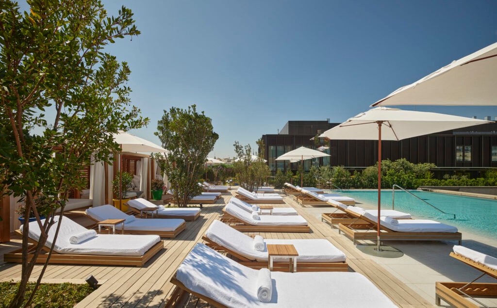 Outdoor pool and sun loungers at The Madrid EDITION