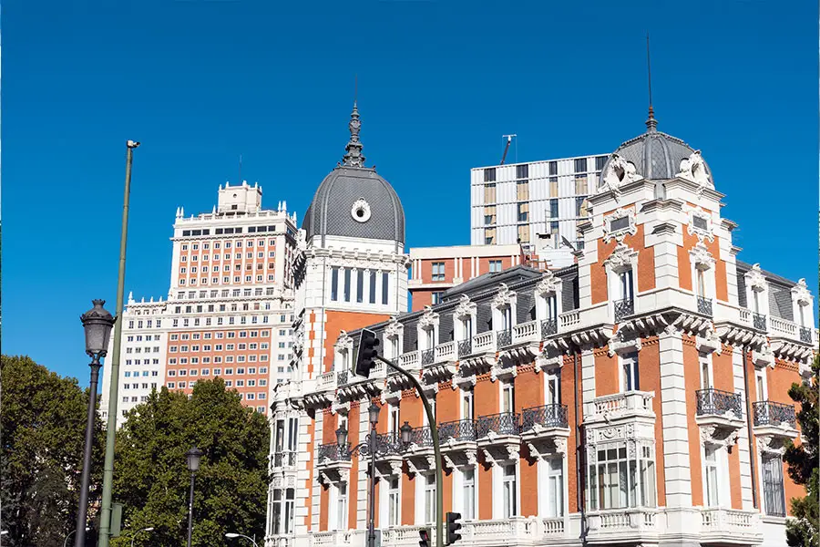 Historic buildings in central Madrid beneath a blue sky